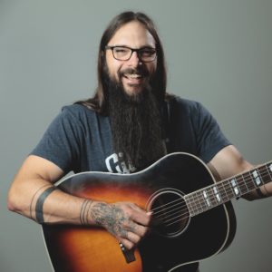 Tony Polecastro holding a guitar