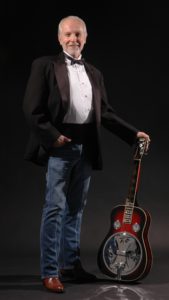 Mike Auldridge standing with Beard guitar