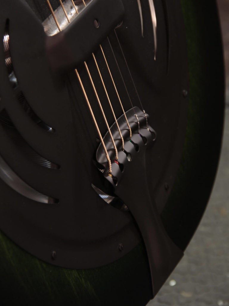 Radio Standard-A resonator guitar close up on tailpiece, Emerald green