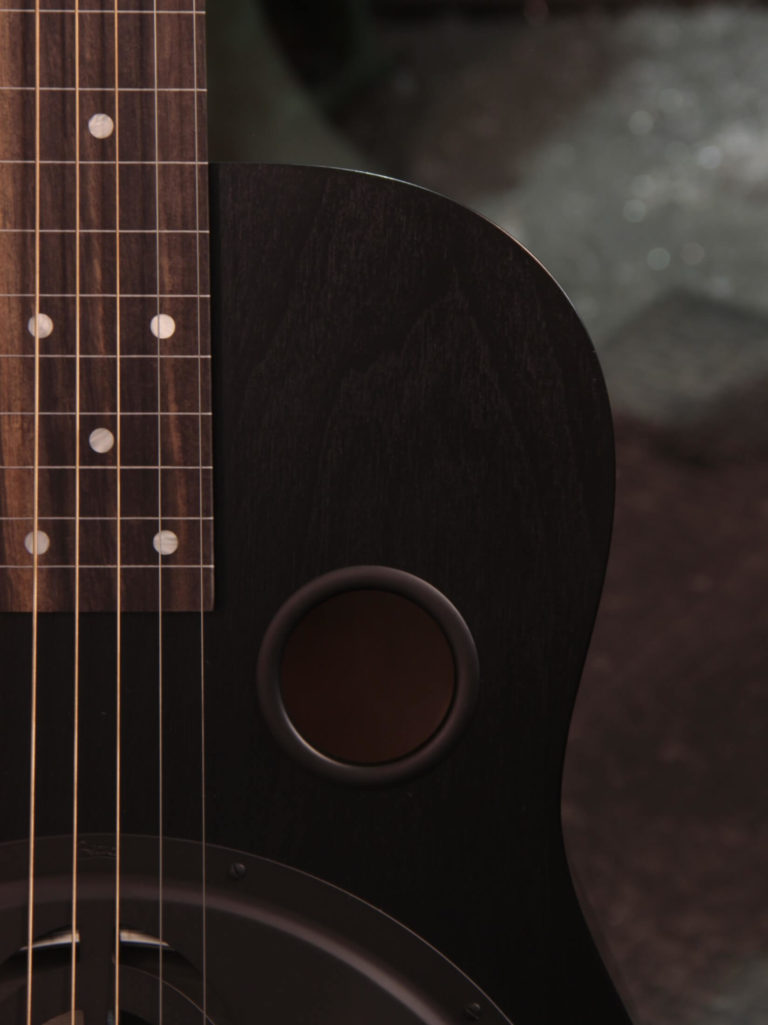 Radio Standard-E resonator guitar close up on soundhole, Black Ice