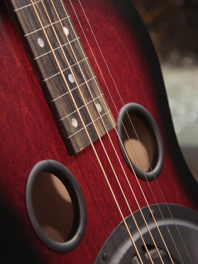 Radio Standard-R resonator guitar close up soundholes, Scarlet sunburst
